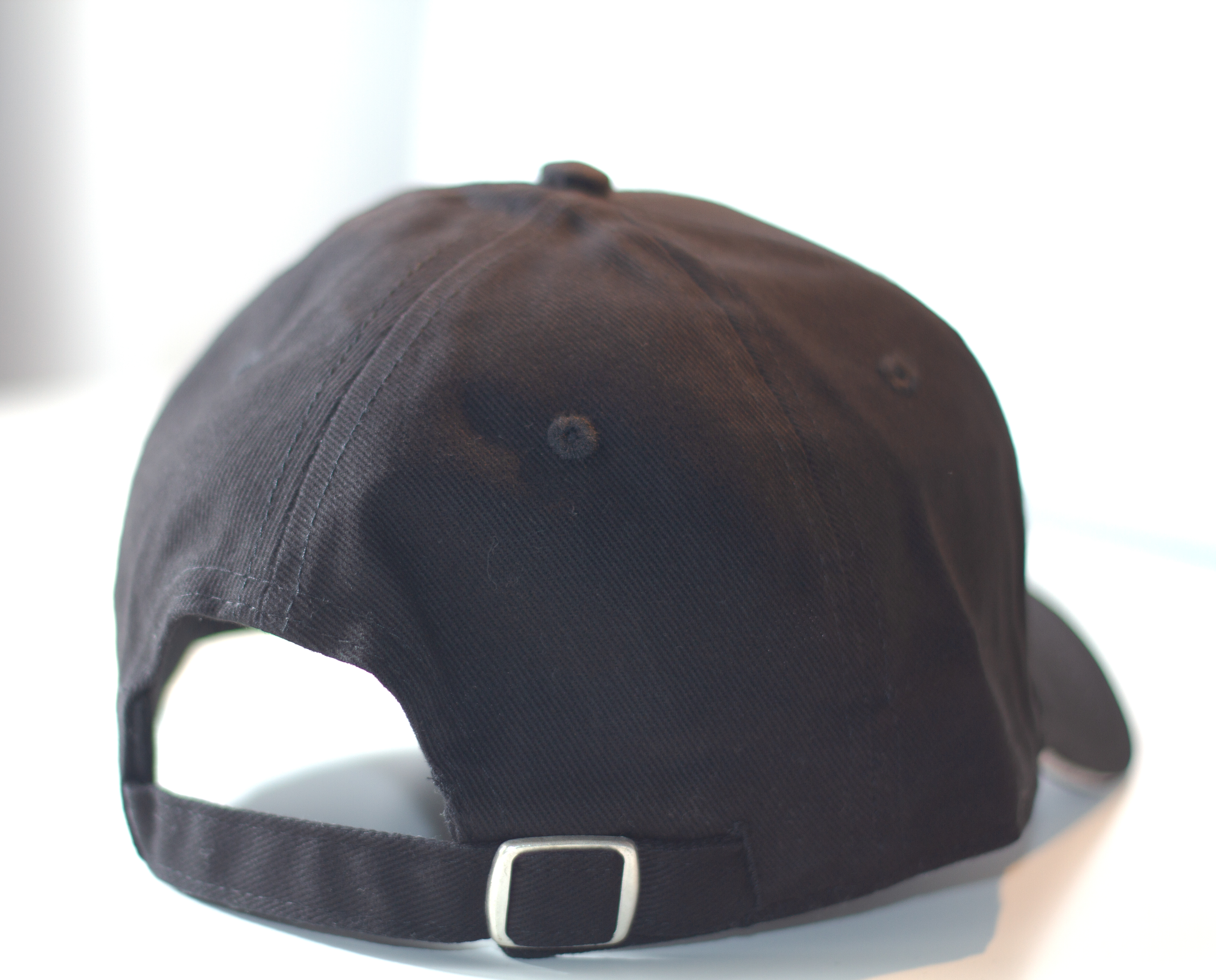 black cap 1 - A structured six-panel cap carrying the Tarsah turtle in raised, tone-on-tone embroidery