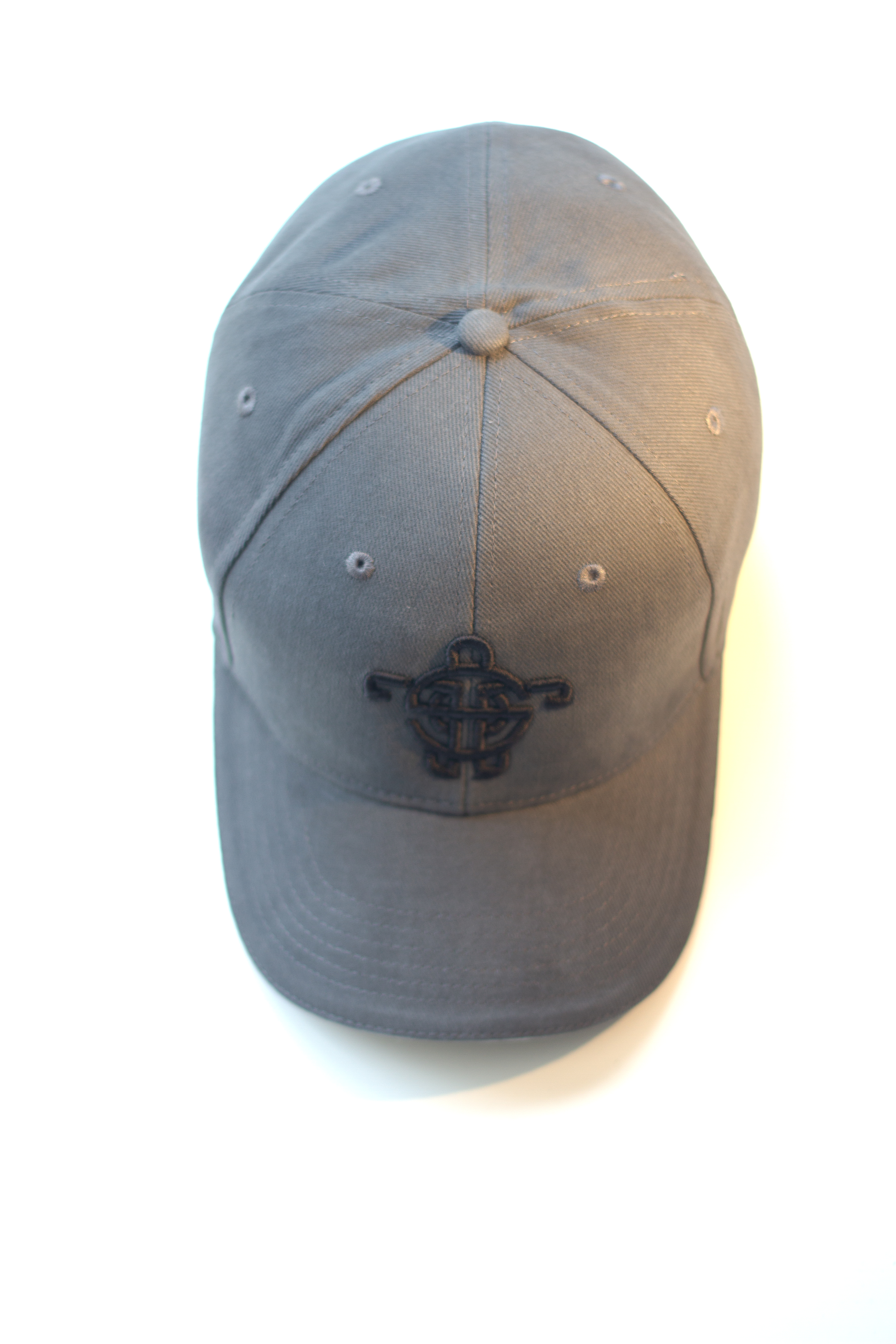 grey cap 1 - A structured six-panel cap carrying the Tarsah turtle in raised, tone-on-tone embroidery